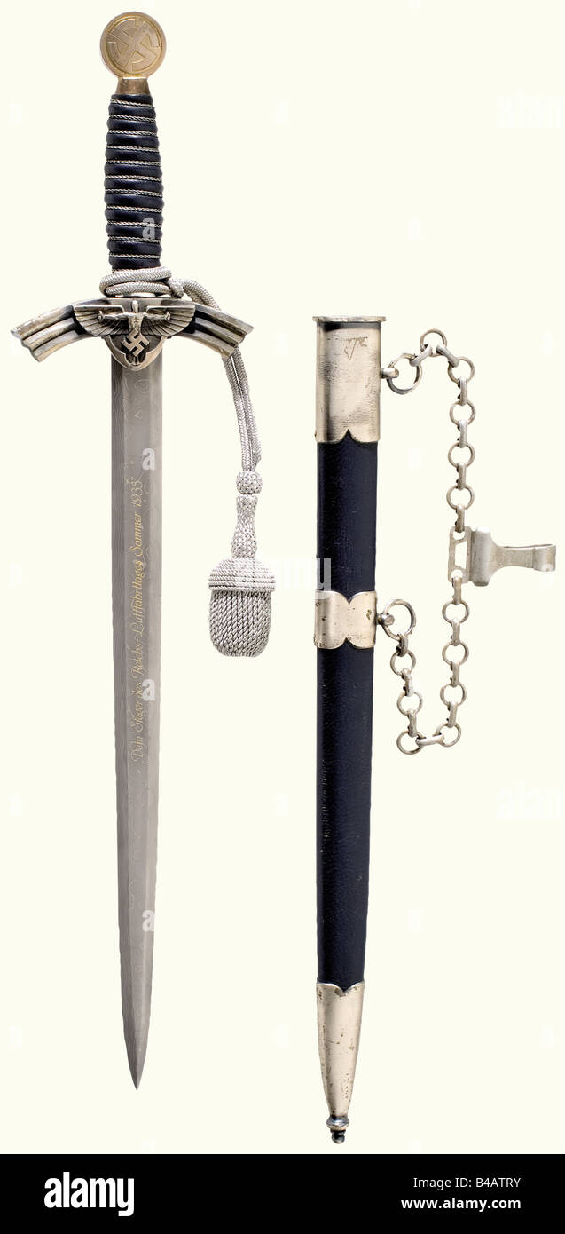 A prototype dagger for a Leader in the NSFK, (National Socialist Flying Corps), complete with hanger and sword knot. Damascus Blade with the gilded dedication, 'Dem Sieger des Reichs-Luftfahrttages Sommer 1935' (To the Victor at the Reichs Aviation Day 1935), and on the reverse side with 'Luftsport Ortsgruppe Düsseldorf' (Düsseldorf Local Air Sport Group) and the manufacturer's inscriptions, 'Eickhorn Solingen' and 'Echt Damast P. Müller' (Genuine Damascus ...). Silver-plated quillons and pommel, blue leather-covered grip with wire winding. Blue leather-covered, Stock Photo