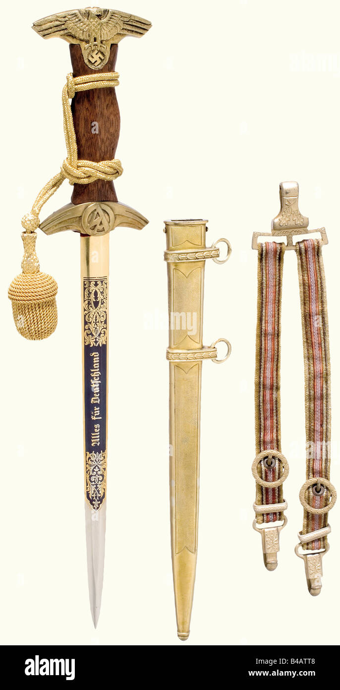 An SA Feldherrnhalle honour dagger, complete with sword knot and hanger. Nickel-plated blade with gilded floral decoration, etched with the motto, and with 'In treuer Kameradschaft 4.10.41 - Viktor Lutze' (In loyal Camaraderie 10 April 41 - Viktor Lutze) on the blued background of the reverse side. Gilded quillons and pommel. Brown wooden grip. Gilded scabbard. Length 43 cm.The breakup of an edged weapons collectionThe pieces offered in this section of the auction were acquired since the post-war years from private possession or directly from the Solingen manuf, Stock Photo