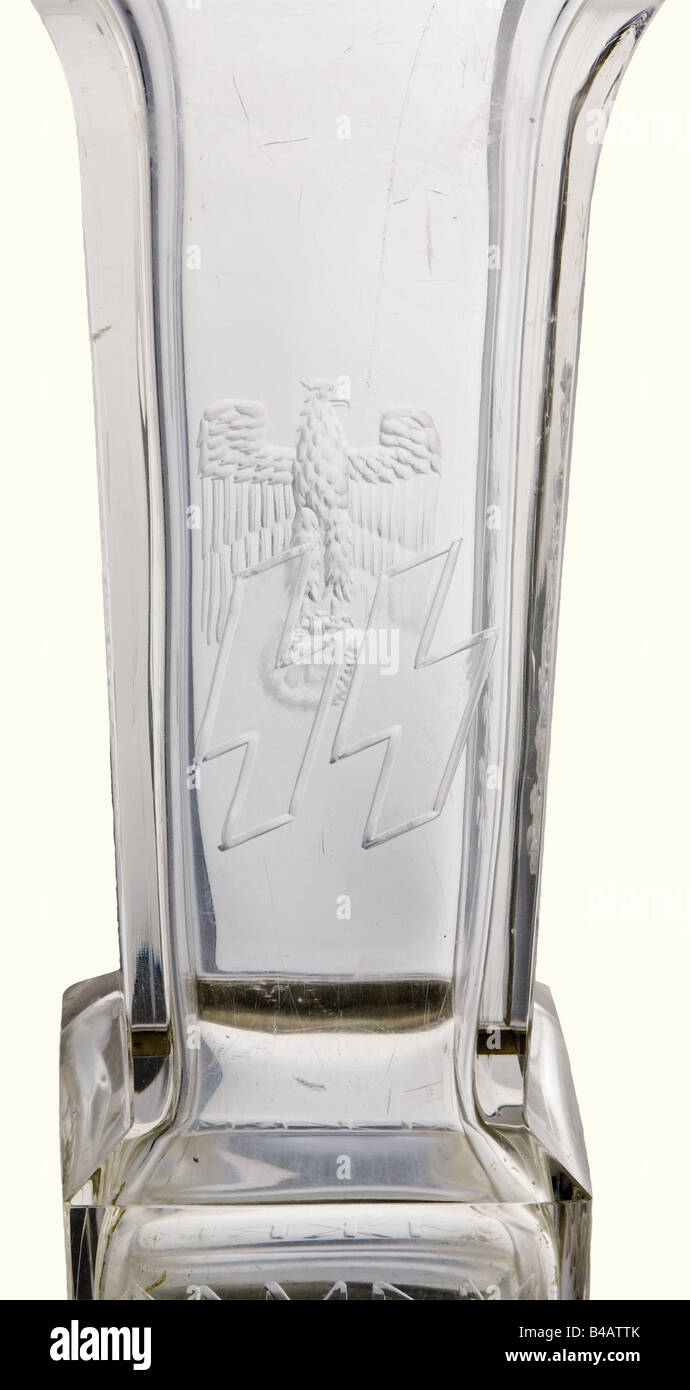 Theodor Eicke - a presentation vase, on the occasion of the award of the Oak Leaves to the Knight's Cross of the Iron Cross on 20 April 1942. Cut lead crystal glass with Wehrmacht eagle on the obverse, reverse with SS runes, laterally oak leaves and swastika décor and a continuous runic inscription 'Meine Ehre heisst Treue' (My Honour is Loyalty). Silver base has the engraved coat of arms of Theodor Eicke and award date '20.April 1942', silver fineness mark and maker's monogram. Height 34 cm. Small chips and scratches, but in good overall condition. Theodor Eic, Stock Photo