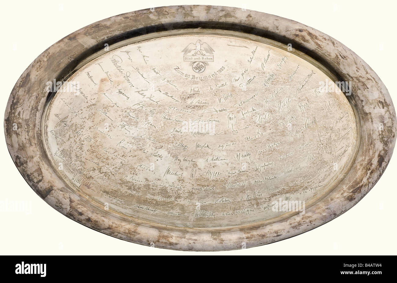 A silver platter of the Reichsnährstand to its constitutional session on the 20th of the Hay Month (July) 1933., Oval shape, engraved with 104 signatures and the emblem of the Reichsnährstand and the date with the peasant term 'Heumond' for July. On the bottom the engraved silversmith's signature 'Lutz & Weiß Pforzheim', and the hallmark '835S' as well as 'LW'. 65 x 4 historic, historical, 1930s, 1930s, 20th century, NS, National Socialism, Nazism, Third Reich, German Reich, Germany, German, National Socialist, Nazi, Nazi period, fascism, object, objects, still, Stock Photo
