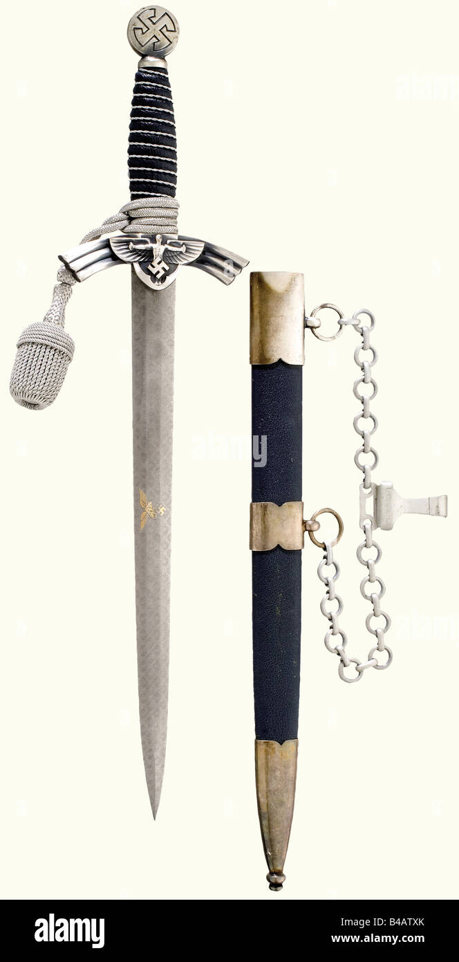 A prototype dagger for a Leader in the NSFK, (National Socialist Flying Corps), complete with hanger and sword knot. Blade with etched Damascus pattern, gilded Luftwaffe eagle, and manufacturer's logo 'SMF'. Silver-plated quillons and pommel. Blue leather-covered grip with wire winding. Blue, leather-covered, scabbard with silver-plated mountings. Length 44 cm.The breakup of an edged weapons collectionThe pieces offered in this section of the auction were acquired since the post-war years from private possession or directly from the Solingen manufacturers, who , Stock Photo
