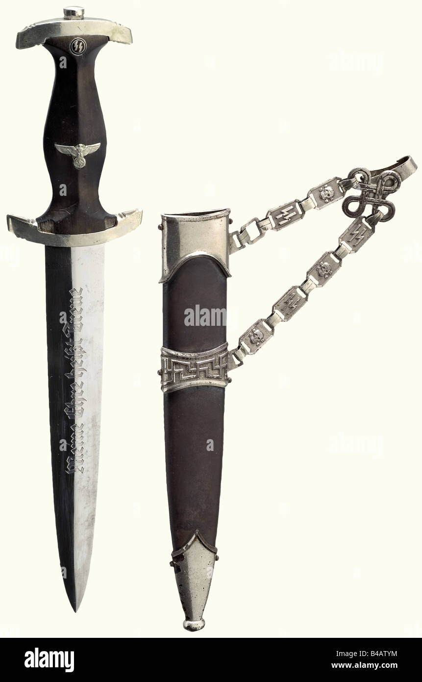 A model 36 dagger, Blade with etched motto and manufacturer's name 'Gottlieb Hammesfahr Solingen-Foche'. Nickel silver quillons, marked 'III', black wooden grip (some chipping) with inset national eagle and enamelled SS runes. Browned iron sheath (spotted) with nickel-plated mountings and an iron chain (with rune stamps 'SS'), the clip tongue missing. Length 34.5 cm.' historic, historical, 1930s, 1930s, 20th century, Waffen-SS, armed division of the SS, armed service, armed services, NS, National Socialism, Nazism, Third Reich, German Reich, Germany, military, , Stock Photo