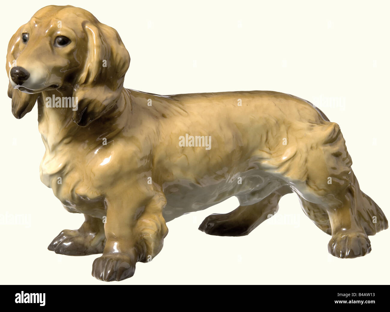 A Long Haired Dachshund Coloured And Glazed Porcelain Figure On