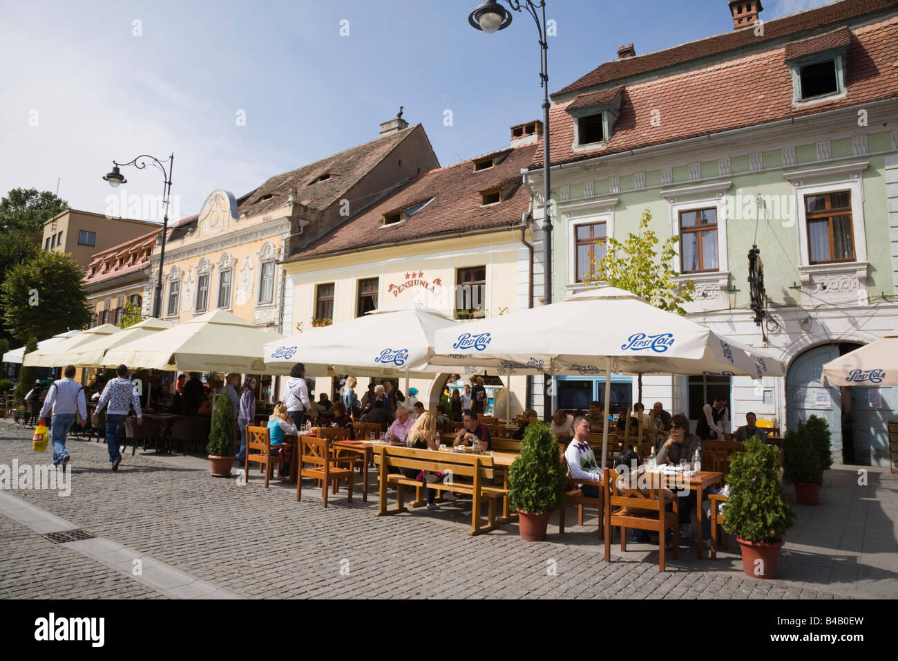 Sibiu Transylvania Romania Street cafes with umbrellas and outdoor seating on pedestrian precinct in historic city centre Stock Photo