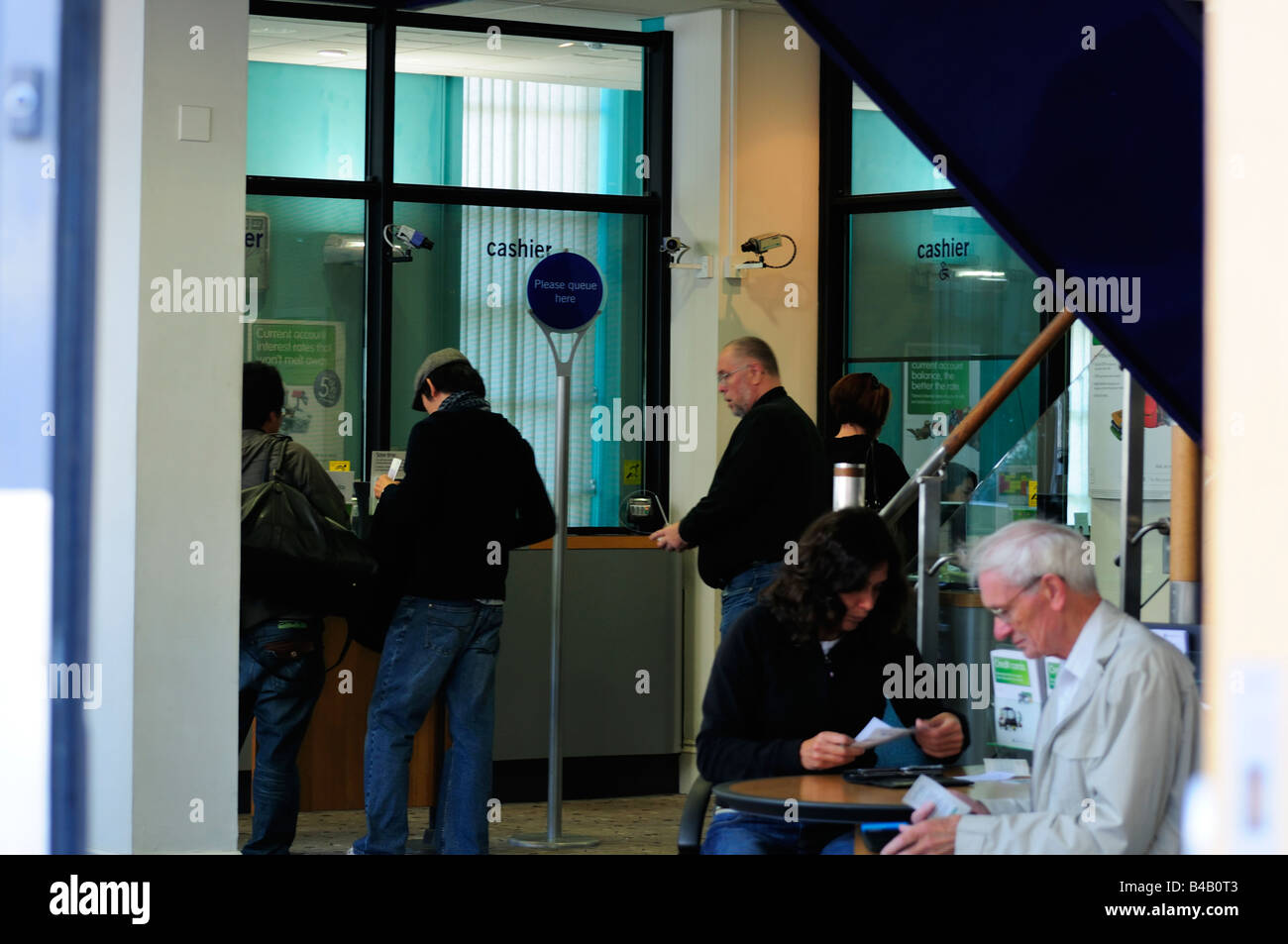 Inside Banking hall people queuing Stock Photo - Alamy