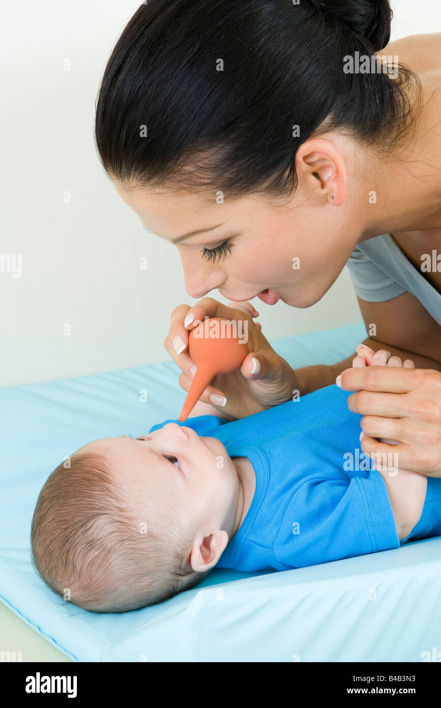 mother cleaning baby's nose Stock Photo Alamy