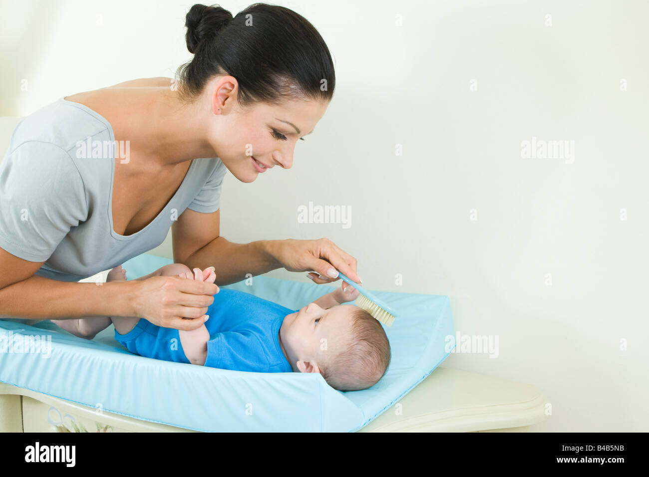 mother brushing baby's hair Stock Photo Alamy