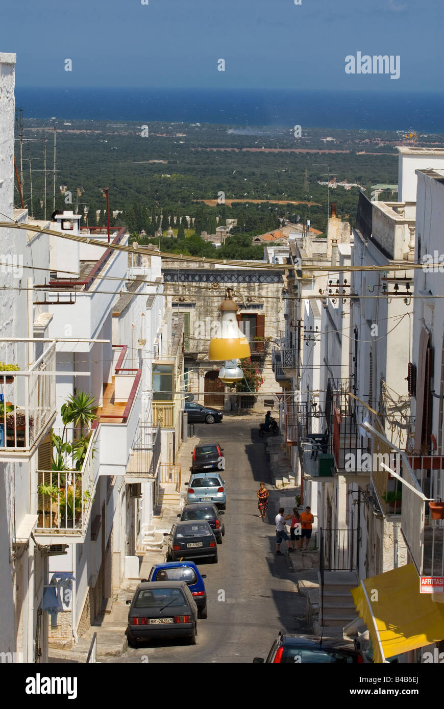 Narrow street in the white city of Ostuni Puglia Italy showing proximity to Adriatic sea Stock Photo