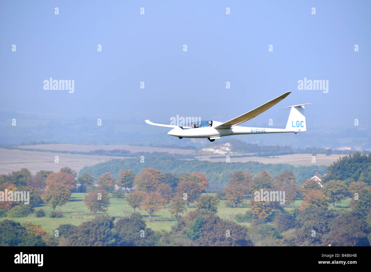 Glider flying over woodland Dunstable Downs England Stock Photo Alamy