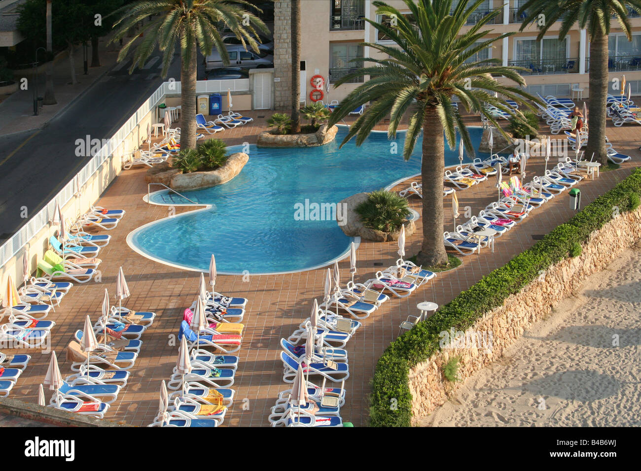Every Sunbed has a towel on it as the sun rises at this hotel in Majorca. Stock Photo