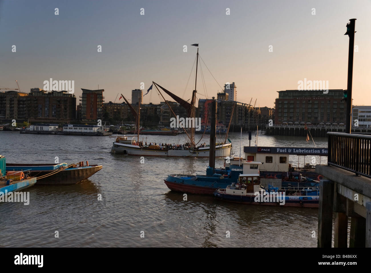 A Thames sailing barge taking Tourists up the River Thames in London in the early evening View is looking towards South London f Stock Photo