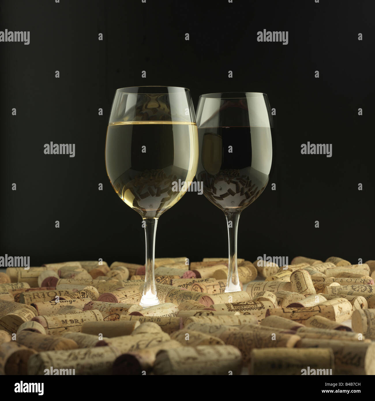 Red & White wine glasses in a 'sea' of corks Stock Photo Alamy