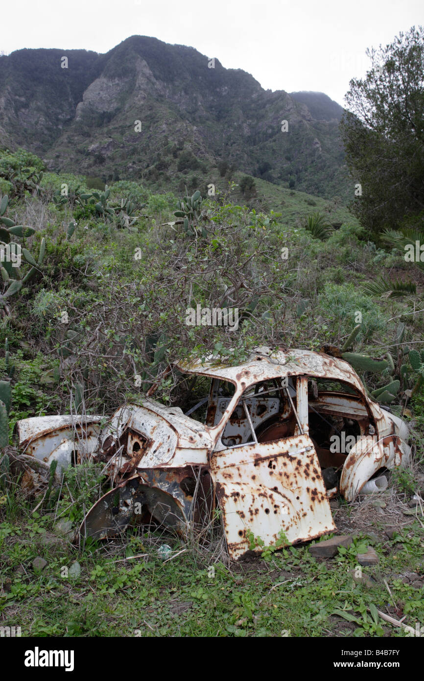 Derelict car near Hermigua La Gomera. This VW beetle was given up quite some time ago. Stock Photo