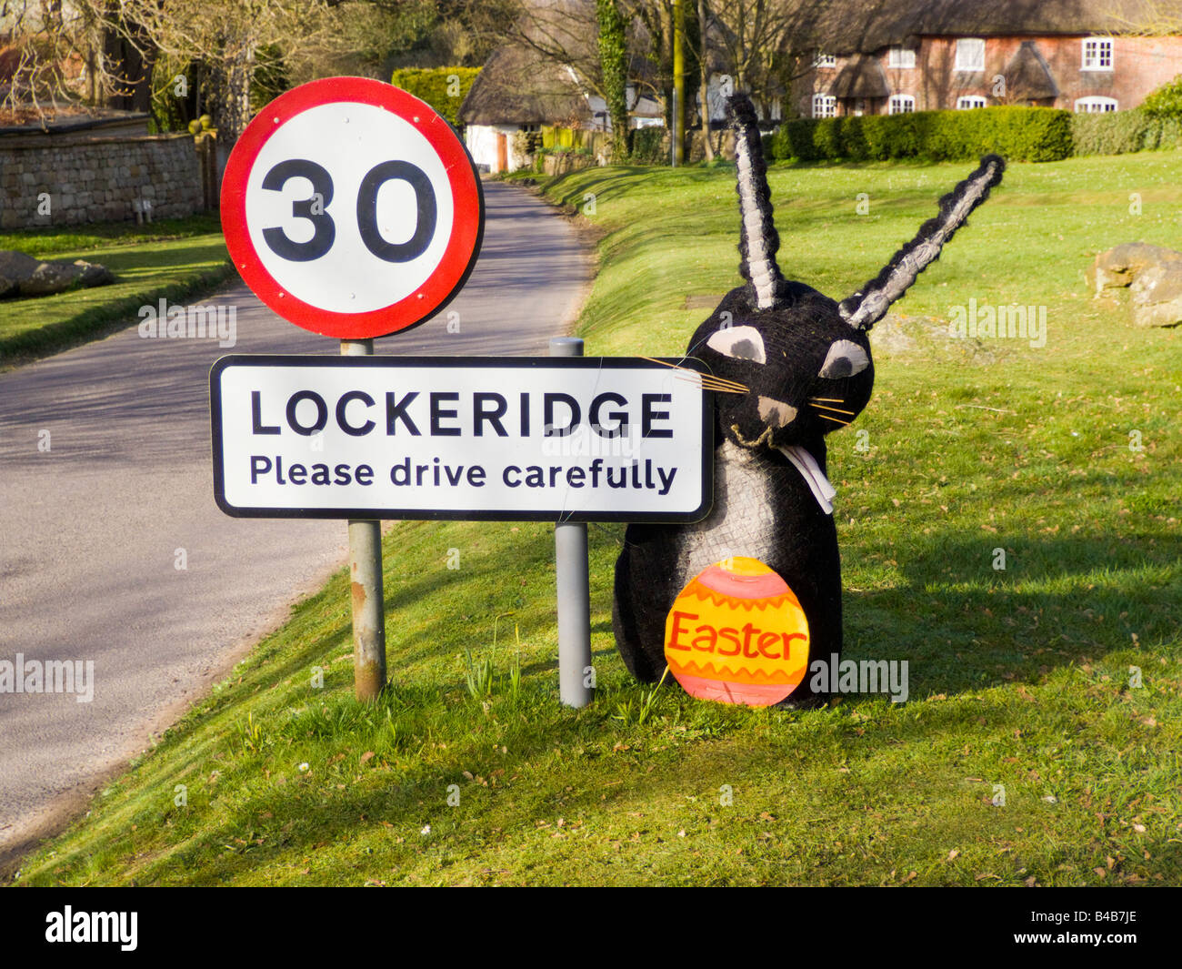 Lockeridge village Wiltshire England Easter bunny by village sign 30 mph miles per hour speed limit restriction Stock Photo