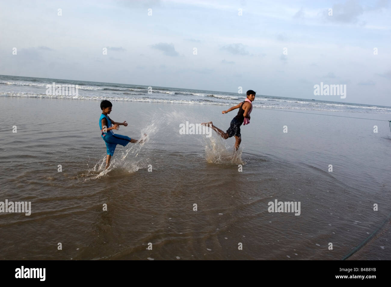 Two boys are enjoying bath at the beach of Digha, West Bengal,India ...