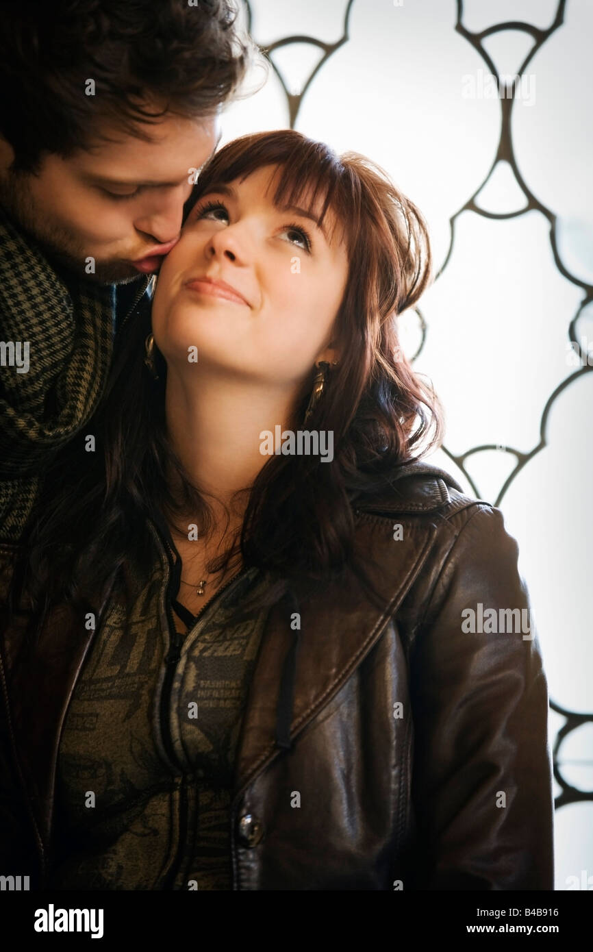 Man kissing woman head hi-res stock photography and images - Alamy