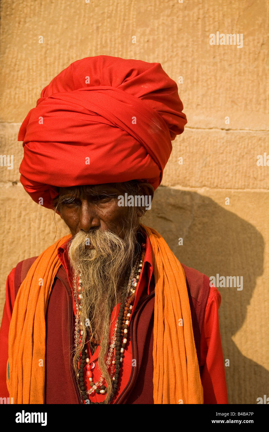 The bearded face of Suchdev Baba Santi a Sadhu in Varanasi. He wears a large red turban in which his long hair is wrapped. Stock Photo