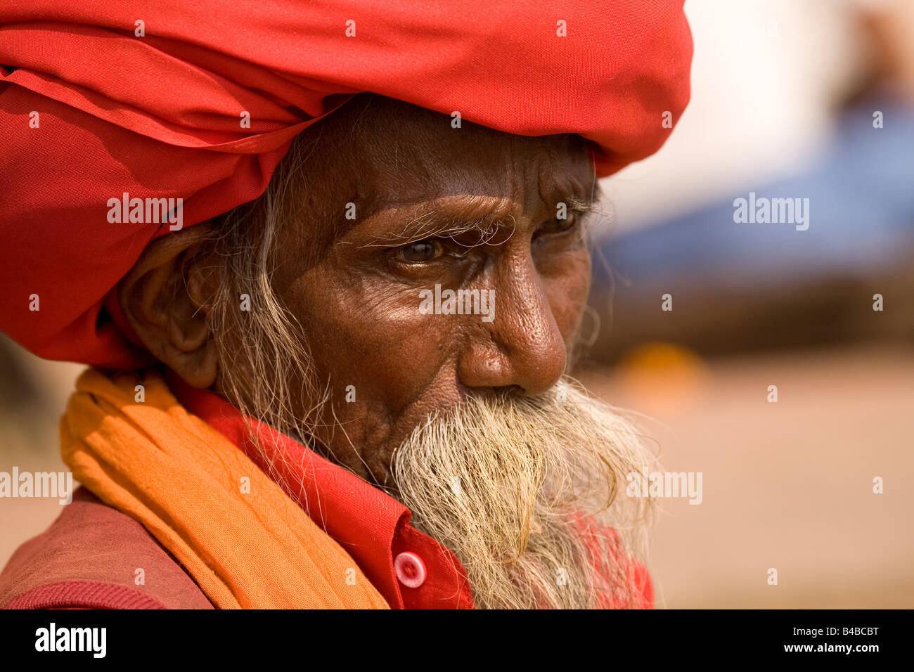 A Sadhu in Varanasi, India. He wears a large red turban in which his long hair is wrapped. Stock Photo