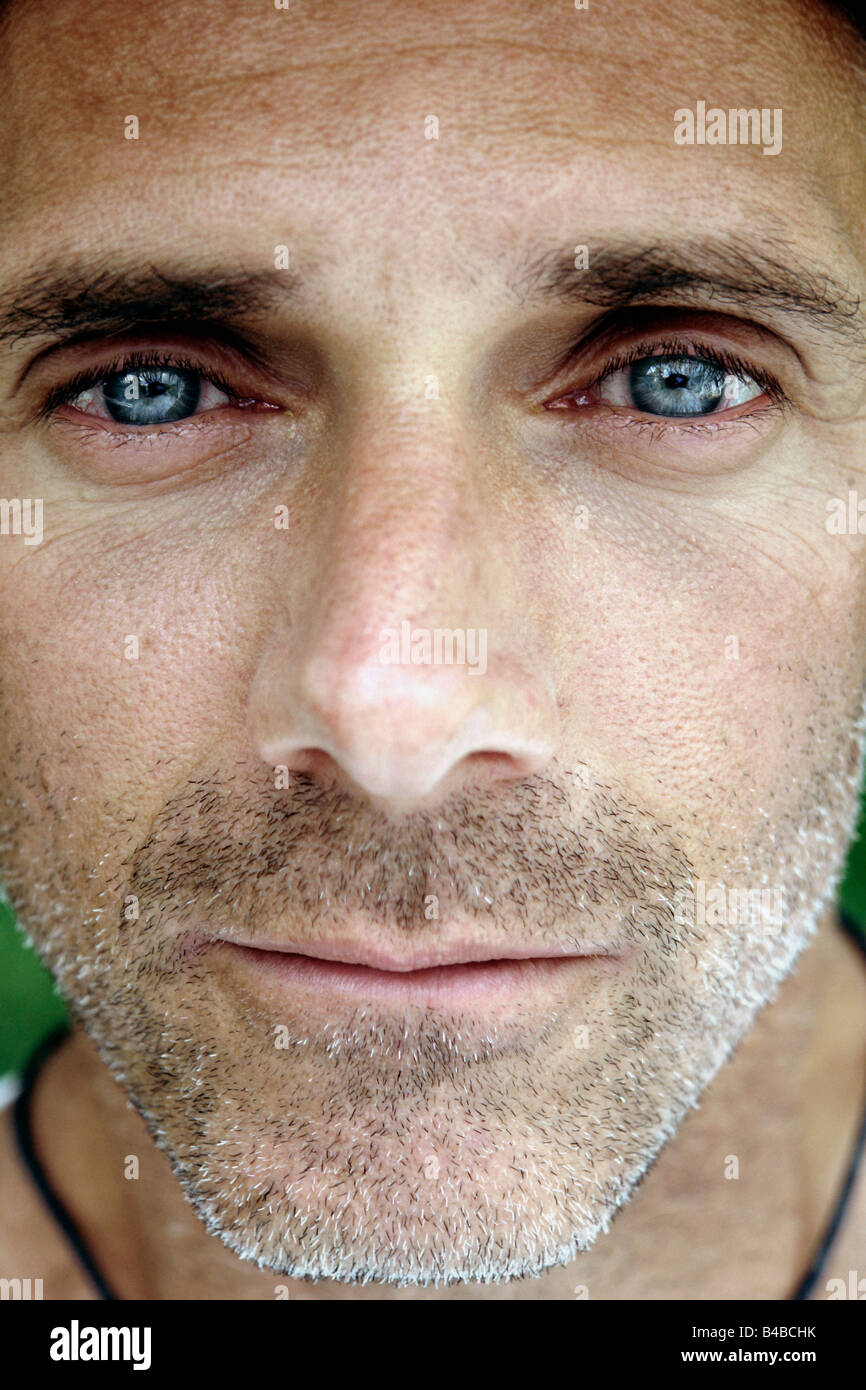 Extreme Closeup Portrait of an Unshaven Man He is looking into Camera Lens Stock Photo