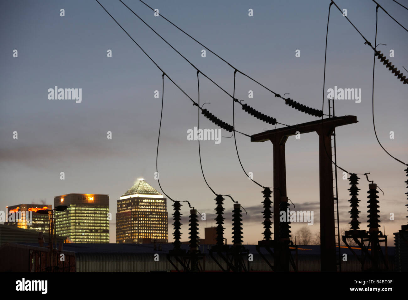 Lights from docklands and Canary Wharf glow in evening with South Bromley electricity substation, London Stock Photo