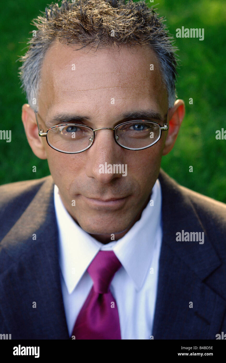Outdoor Portrait of a Baby Boomer Aged Businessman Wearing Eyeglasses and a Suit Stock Photo