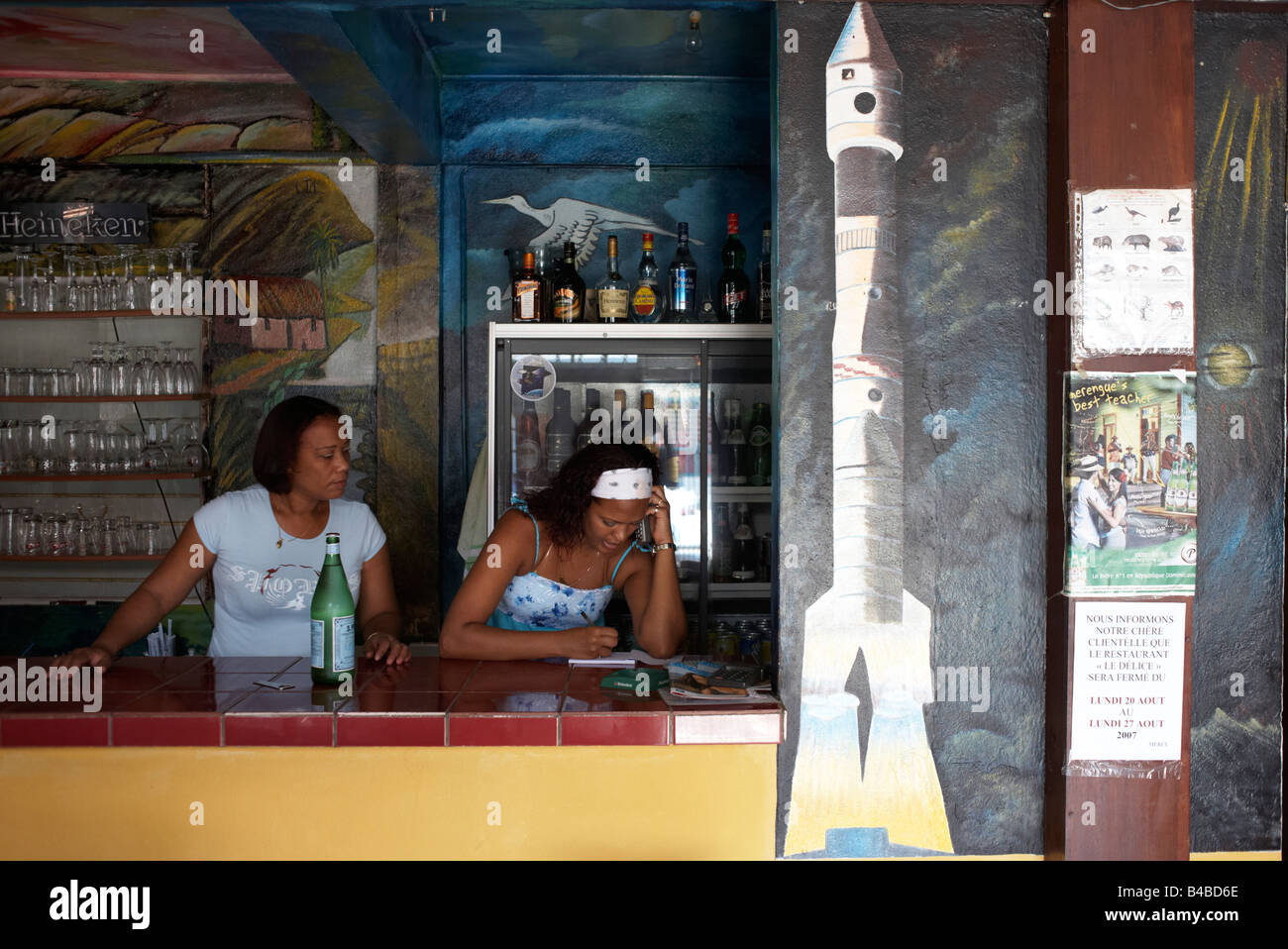 Taking telephone orders near rocket painting at the Délice restaurant in the old quarter of Kourou, French Guiana Stock Photo