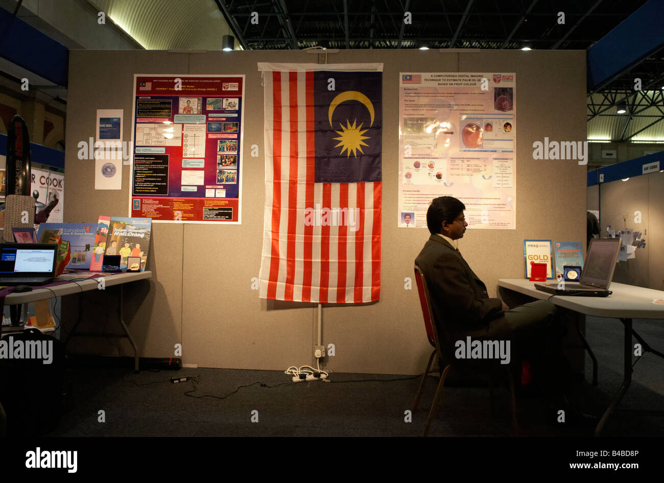 A patient Malaysian entrepreneur awaits investment for his concept at an inventors' fair in Alexandra Palace  London Stock Photo