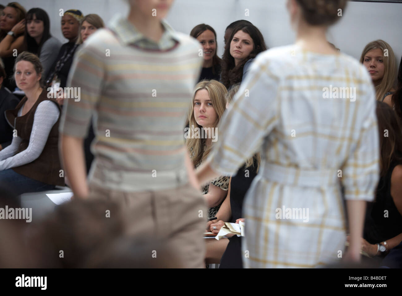 Models scrutinized by media at British couture designer Margaret Howell's Autumn fashion show in her London design studio Stock Photo