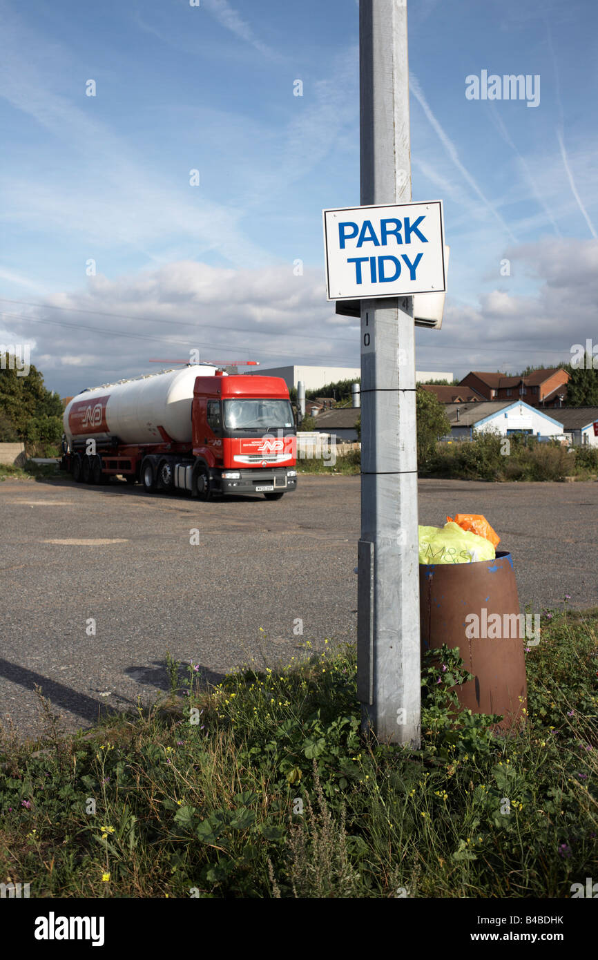 By a full rubbish bin, sign on lamp post telling HGV drivers to park their lorries tidily in overnight lorry park, Grays Essex Stock Photo