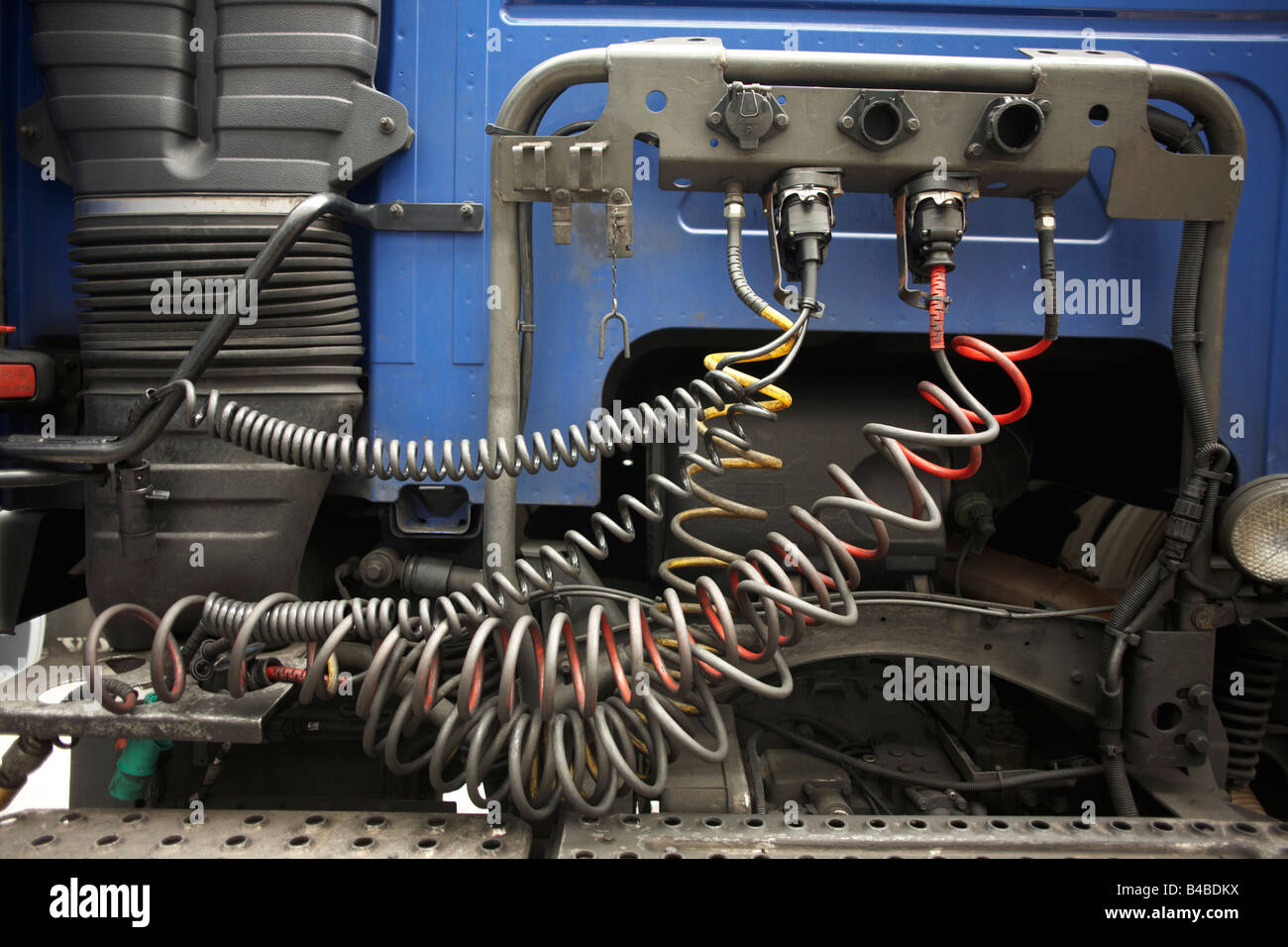 The rear of a lorry cab, its chassis and hydraulic control hoses of an