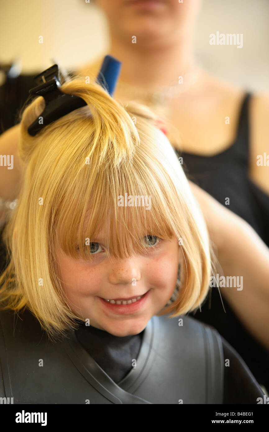 A Young Girl Having Her Haircut At A Hairdressers Stock