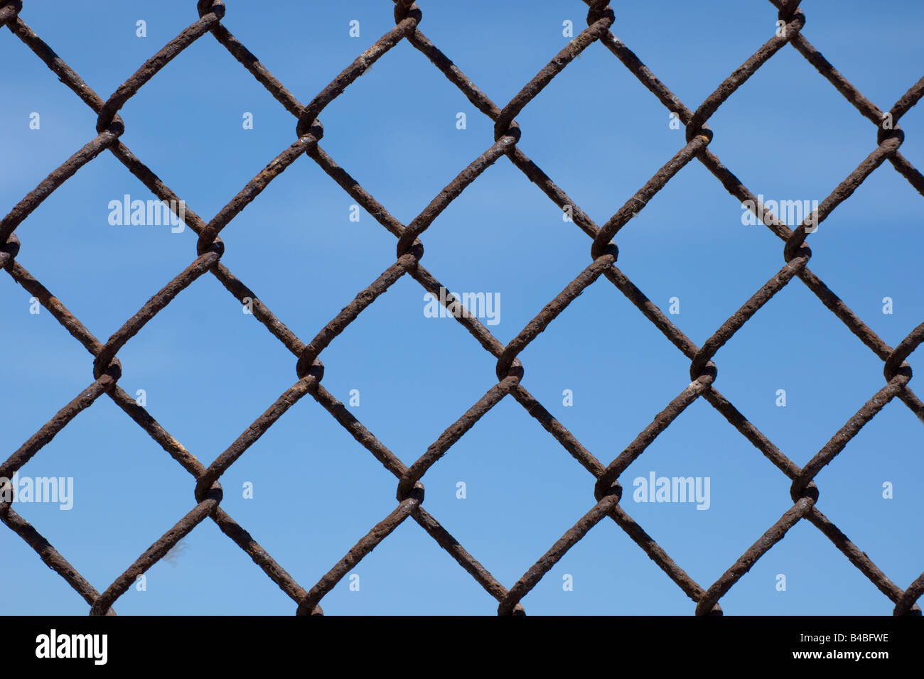 Rusted chain link fence against blue sky Stock Photo Alamy