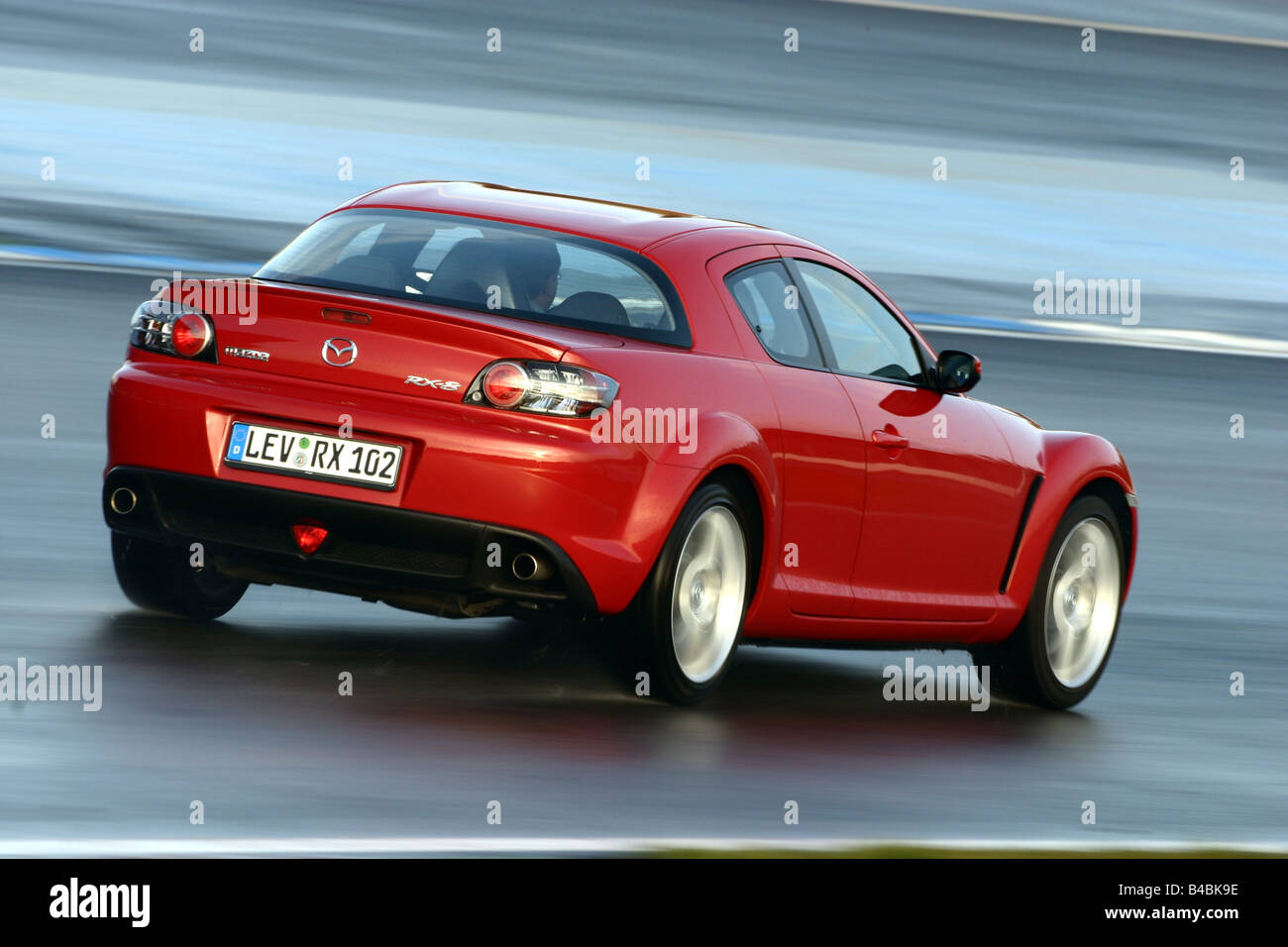 Car, Mazda RX 8, roadster, model year 2002-, red, coupe/Coupe, FGHDS, driving, diagonal from the back, rear view, side view, Tes Stock Photo