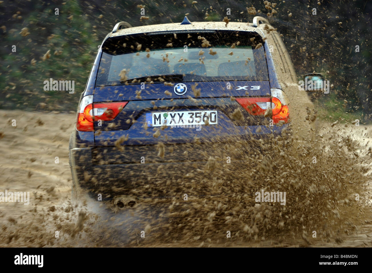 Car, BMW X3 3.0i, cross country vehicle, model year 2003-, dark blue, FGHDS, driving, diagonal from the back, rear view, offroad Stock Photo