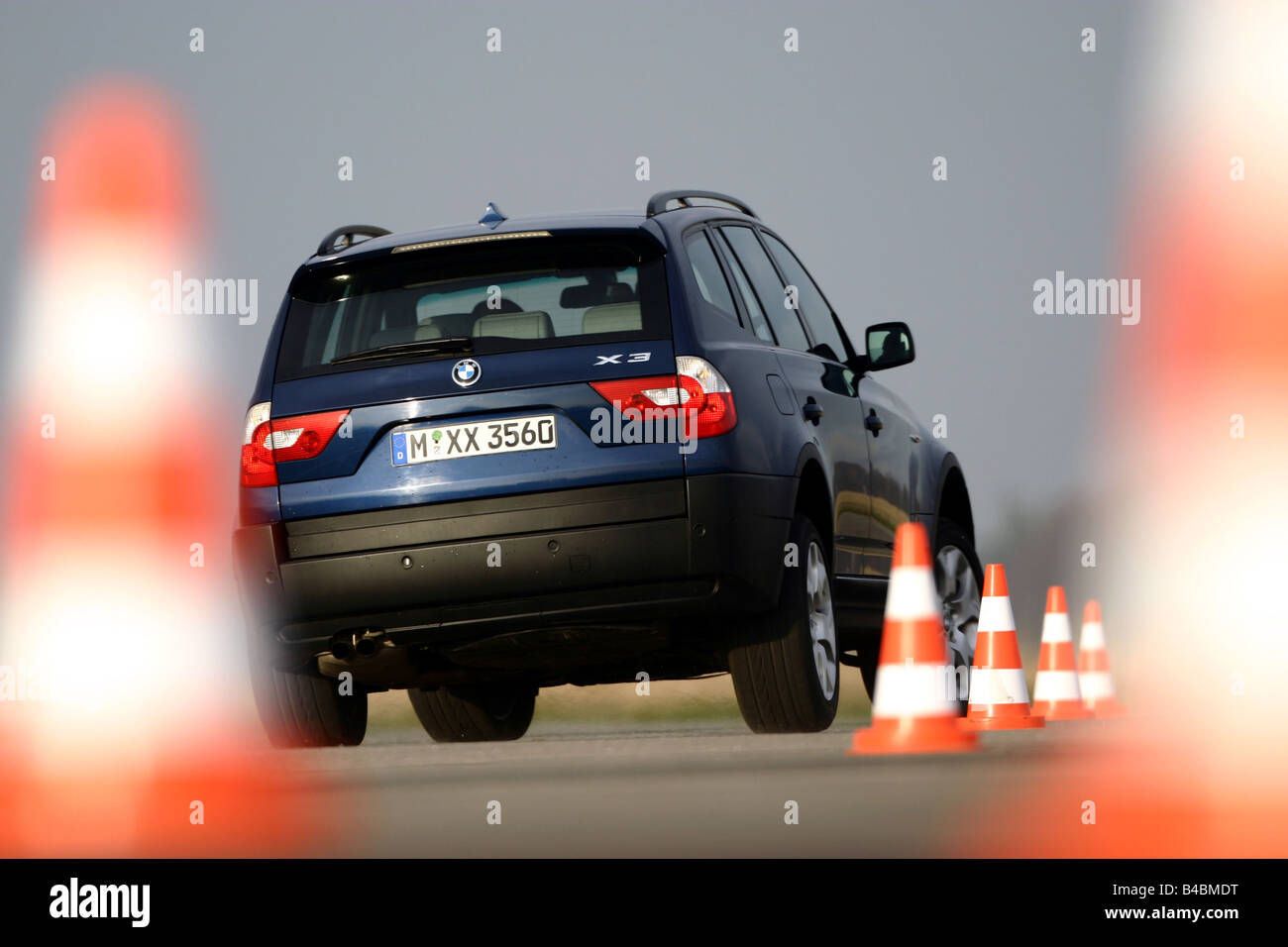 Car, BMW X3 3.0i, cross country vehicle, model year 2003-, dark blue, FGHDS, driving, diagonal from the back, rear view, test tr Stock Photo