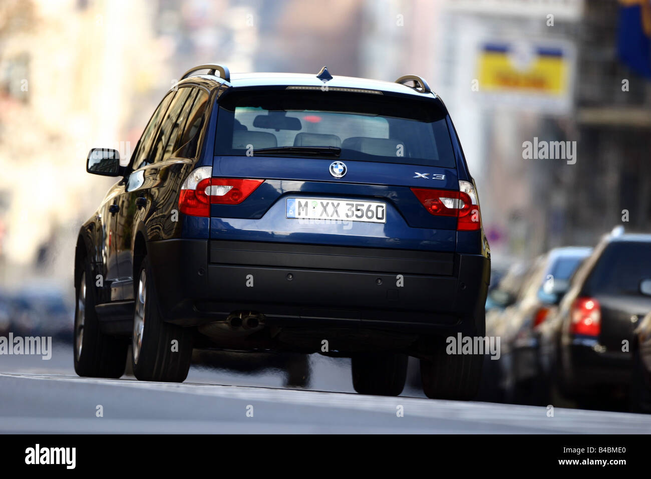 Car, BMW X3 3.0i, cross country vehicle, model year 2003-, dark blue, FGHDS, driving, diagonal from the back, rear view, City Stock Photo