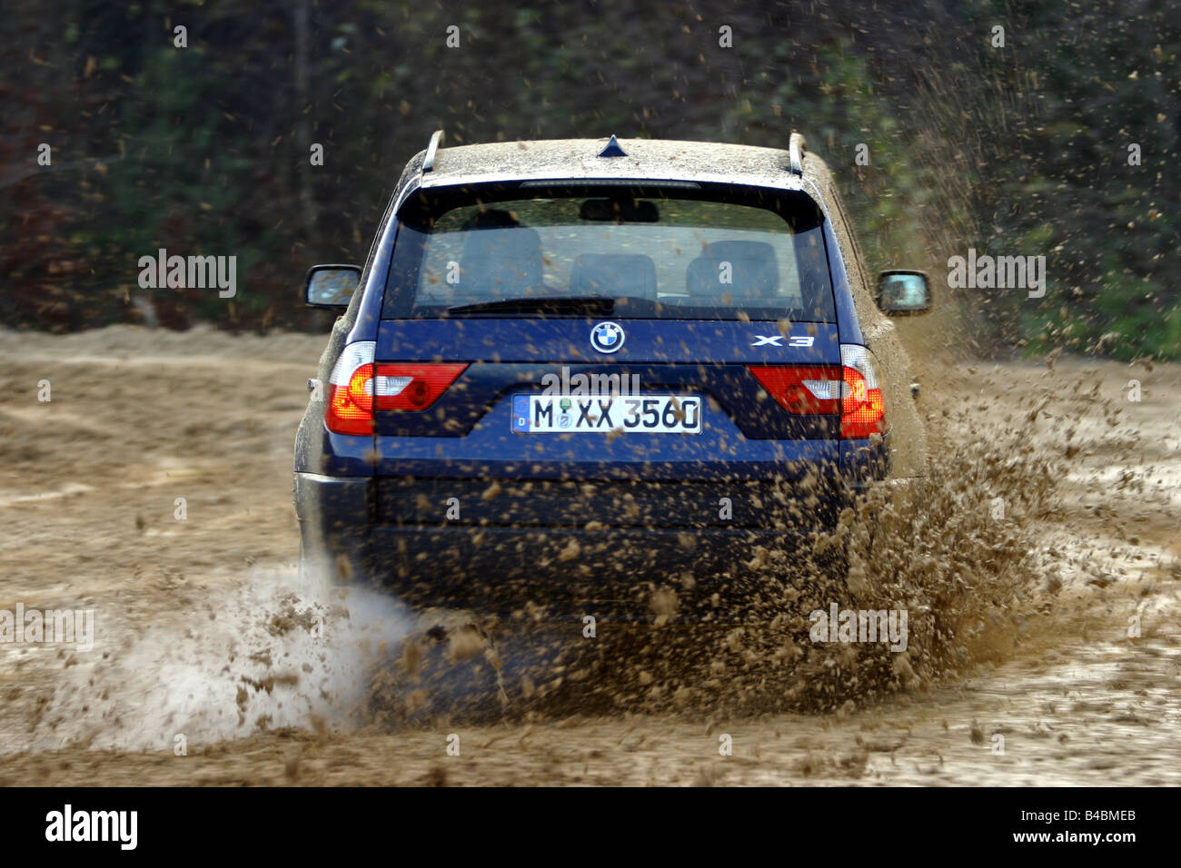 Car, BMW X3 3.0i, cross country vehicle, model year 2003-, dark blue, FGHDS, driving, diagonal from the back, rear view, offroad Stock Photo
