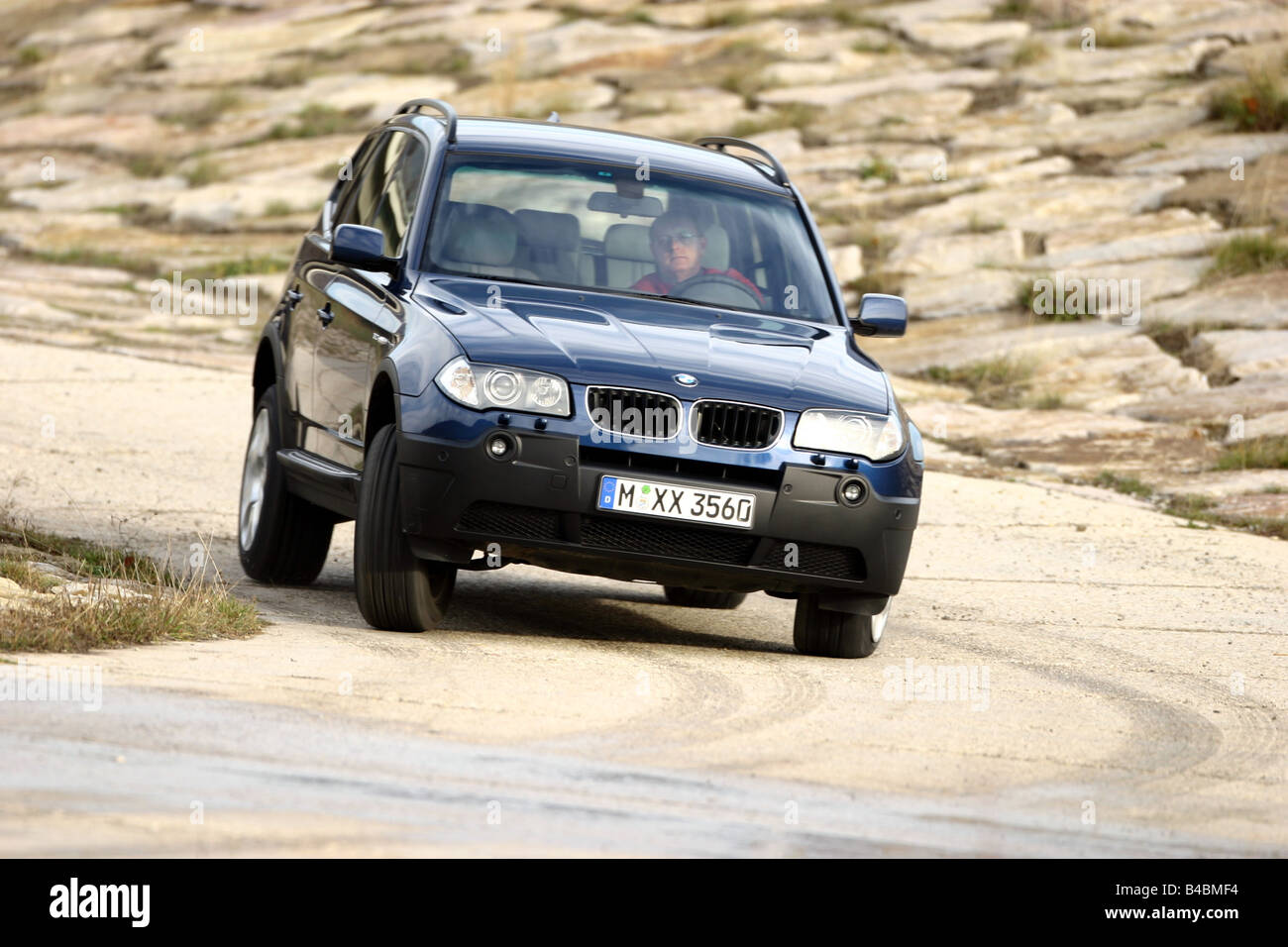 Car, BMW X3 3.0i, cross country vehicle, model year 2003-, dark blue, FGHDS, driving, diagonal from the front, frontal view, off Stock Photo
