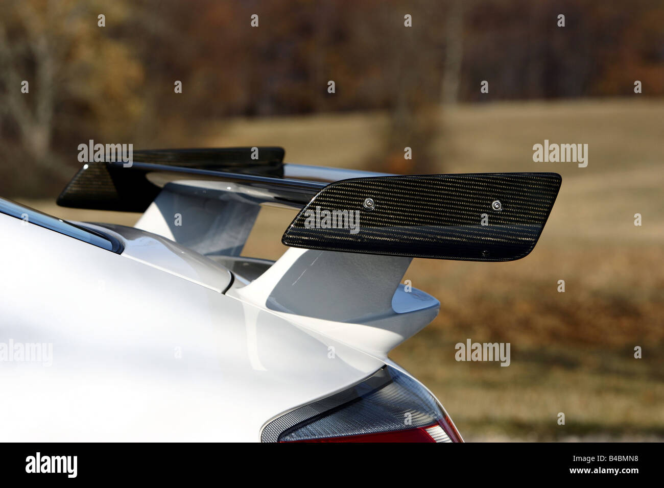 Spoiler of a red sports car in a white room Stock Photo - Alamy