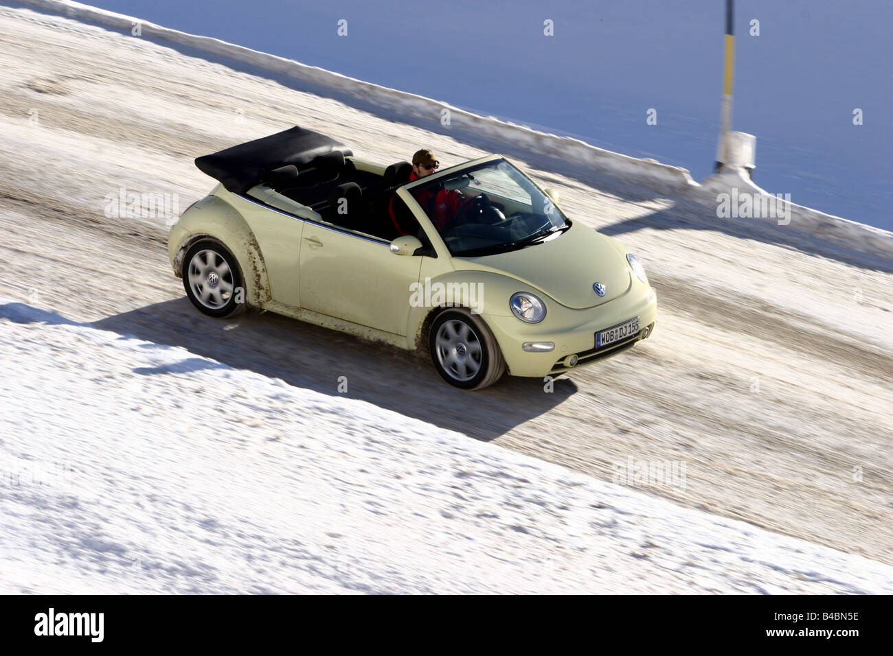 Car, VW Volkswagen New Beetle Convertible, model year 2003-, creme, open top, Winter, Snow, FGHDS, driving, frontal view, side v Stock Photo