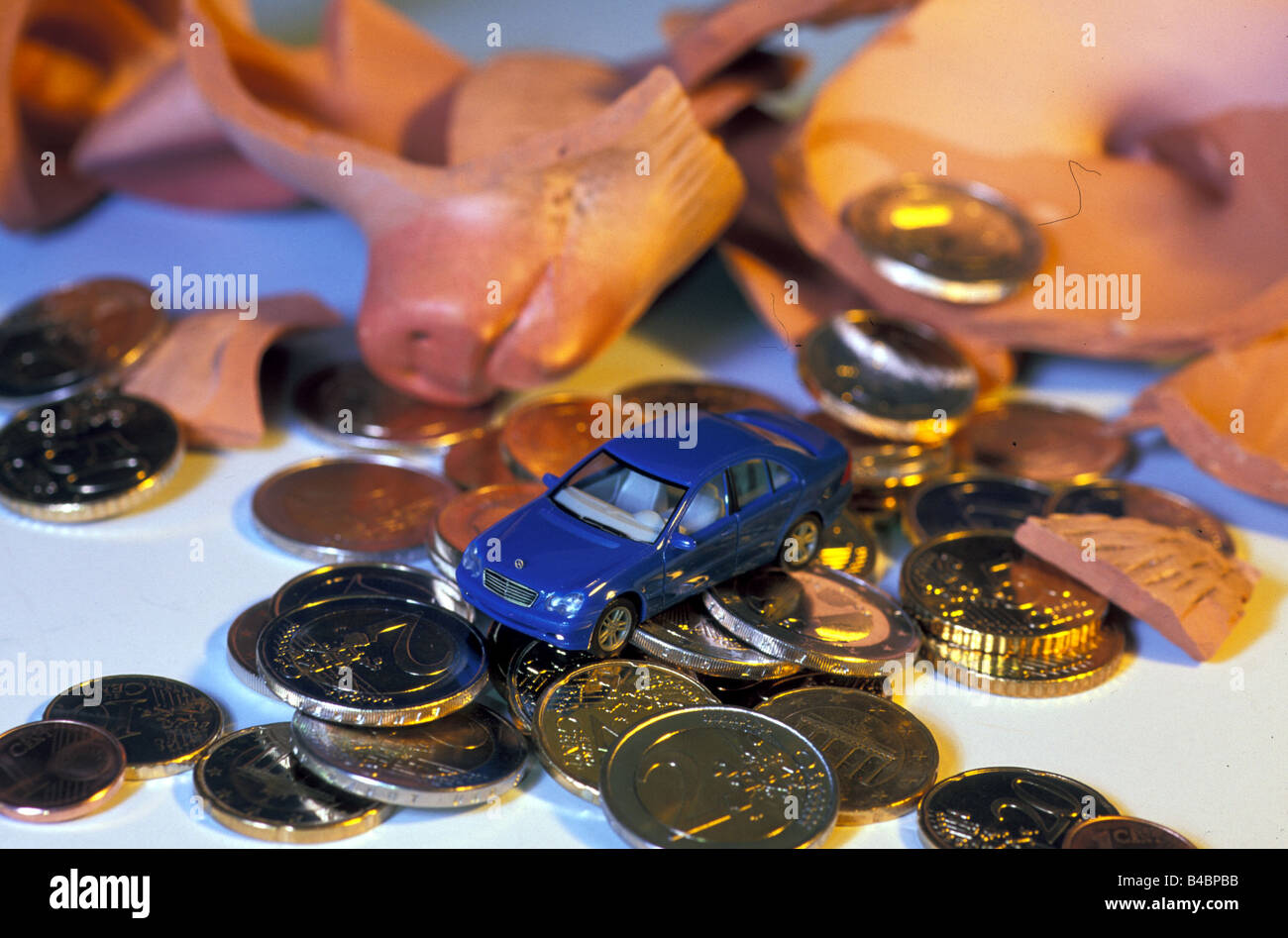Car, approx. purchase, Model car with eurocoins, Euros, broken piggy bank Stock Photo