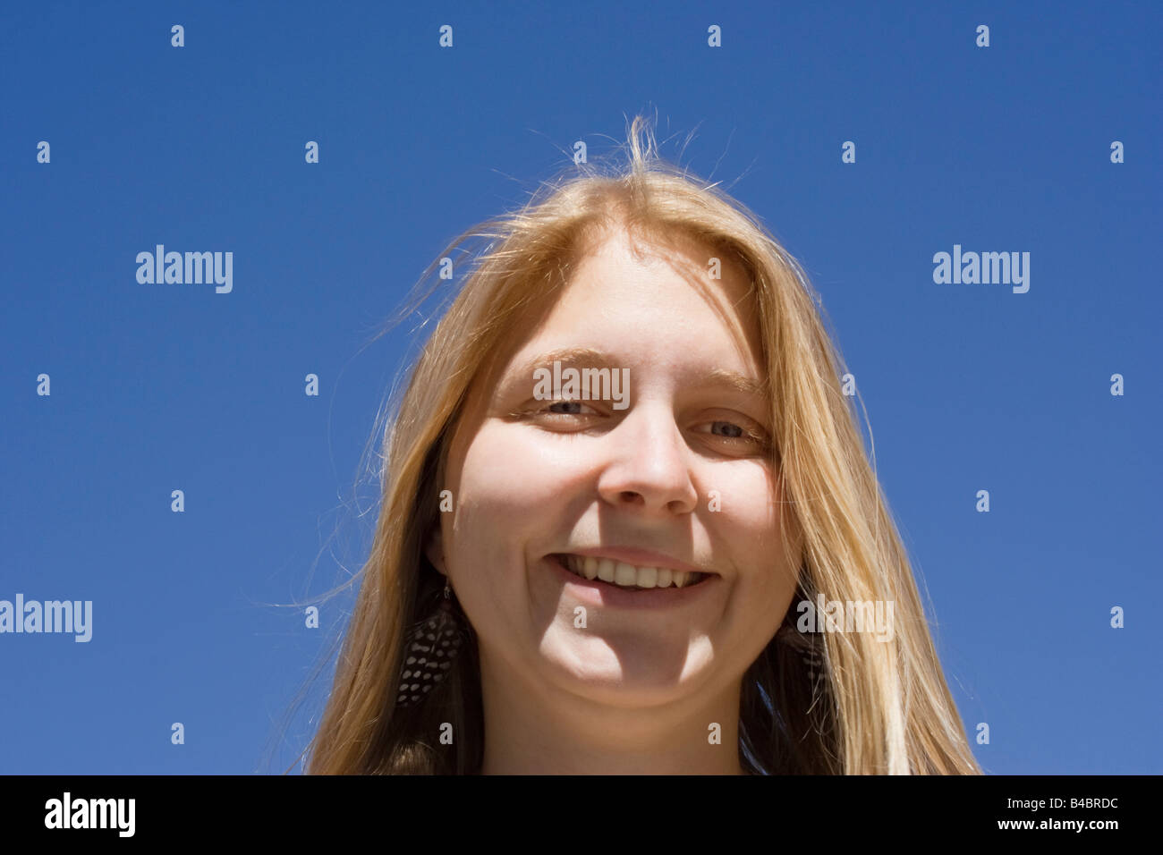 young woman - portrait against a blue sky Stock Photo - Alamy