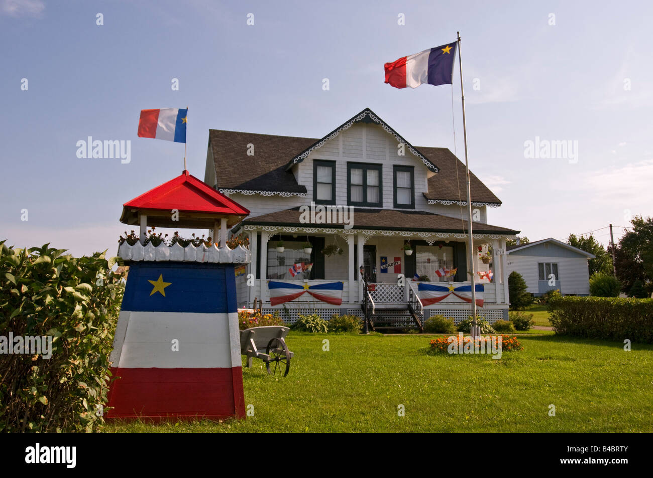 City of Caraquet House with Acadian flags Stock Photo