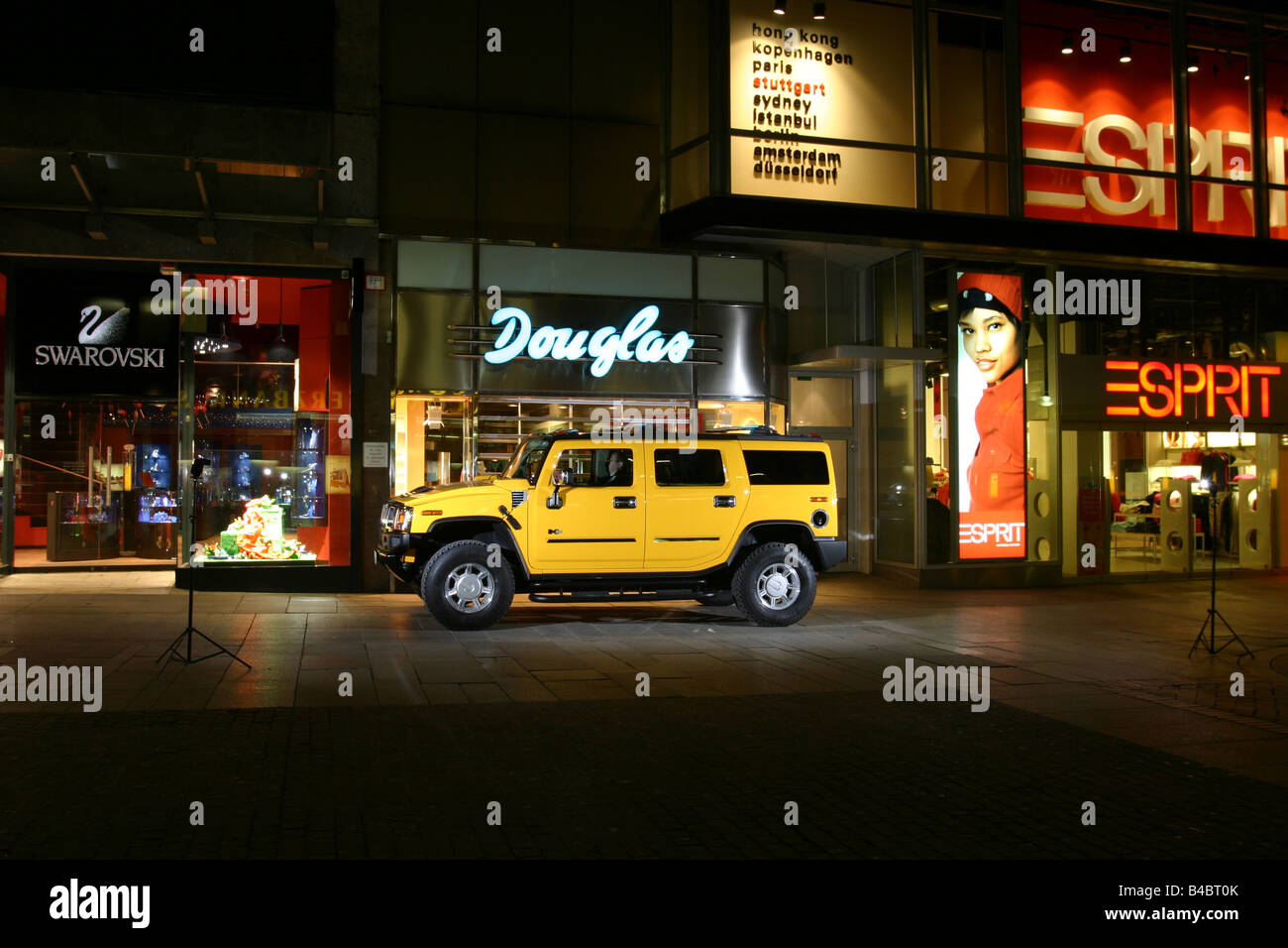 Car, Chevrolet Hummer H2, cross country vehicle, model year 2001-, yellow, driving, side view, City, at night, photographer: Han Stock Photo
