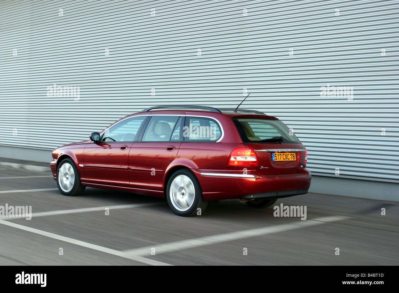 Car, Jaguar X-Type Estate 2.0 d, model year 2004-, medium class, hatchback, ruby colored, driving, diagonal from the back, rear Stock Photo