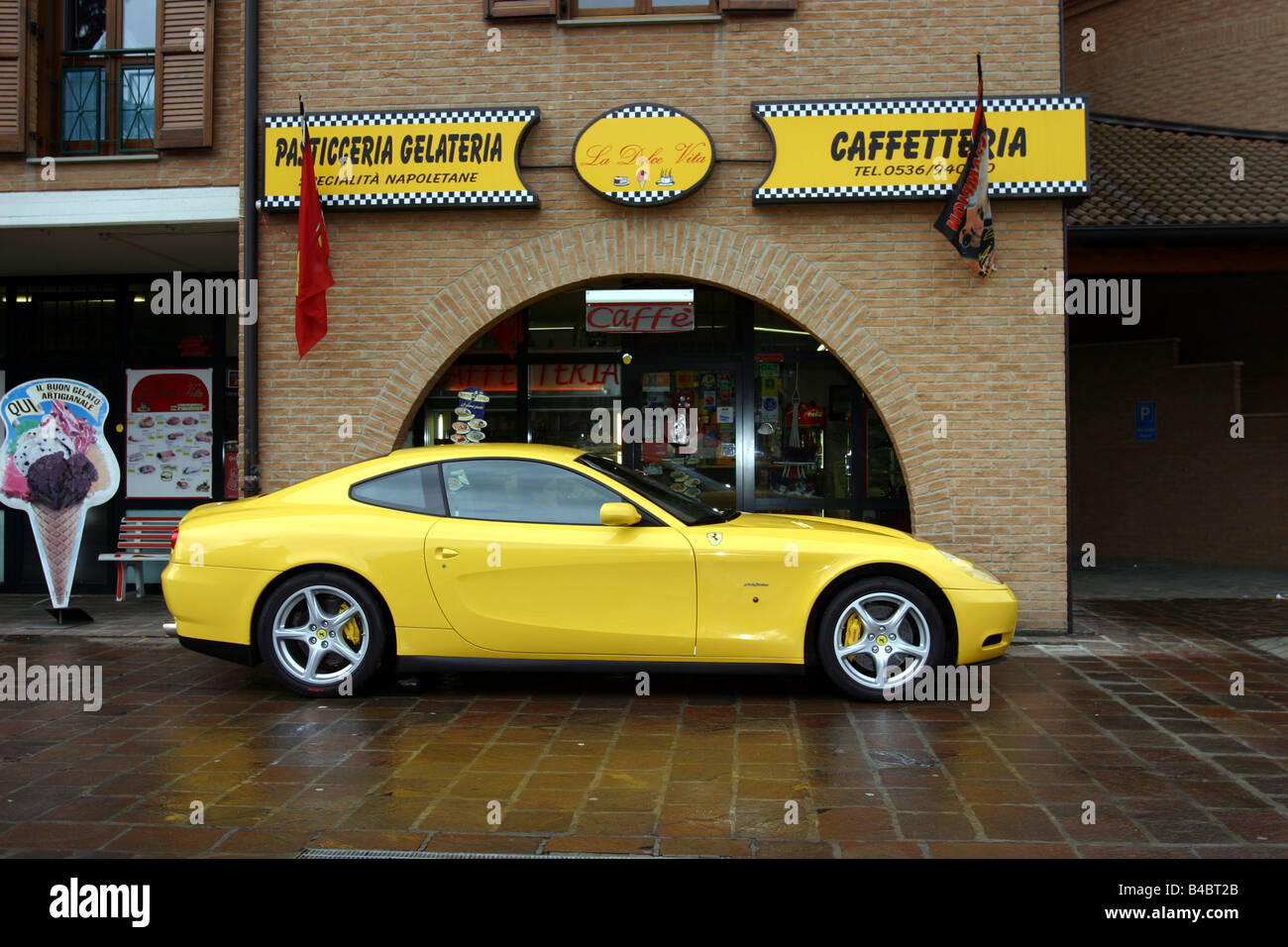 Car, Ferrari 612 Sapprox.lietti, roadster, model year 2004-, coupe/Coupe, yellow, standing, upholding, side view, City, photogra Stock Photo
