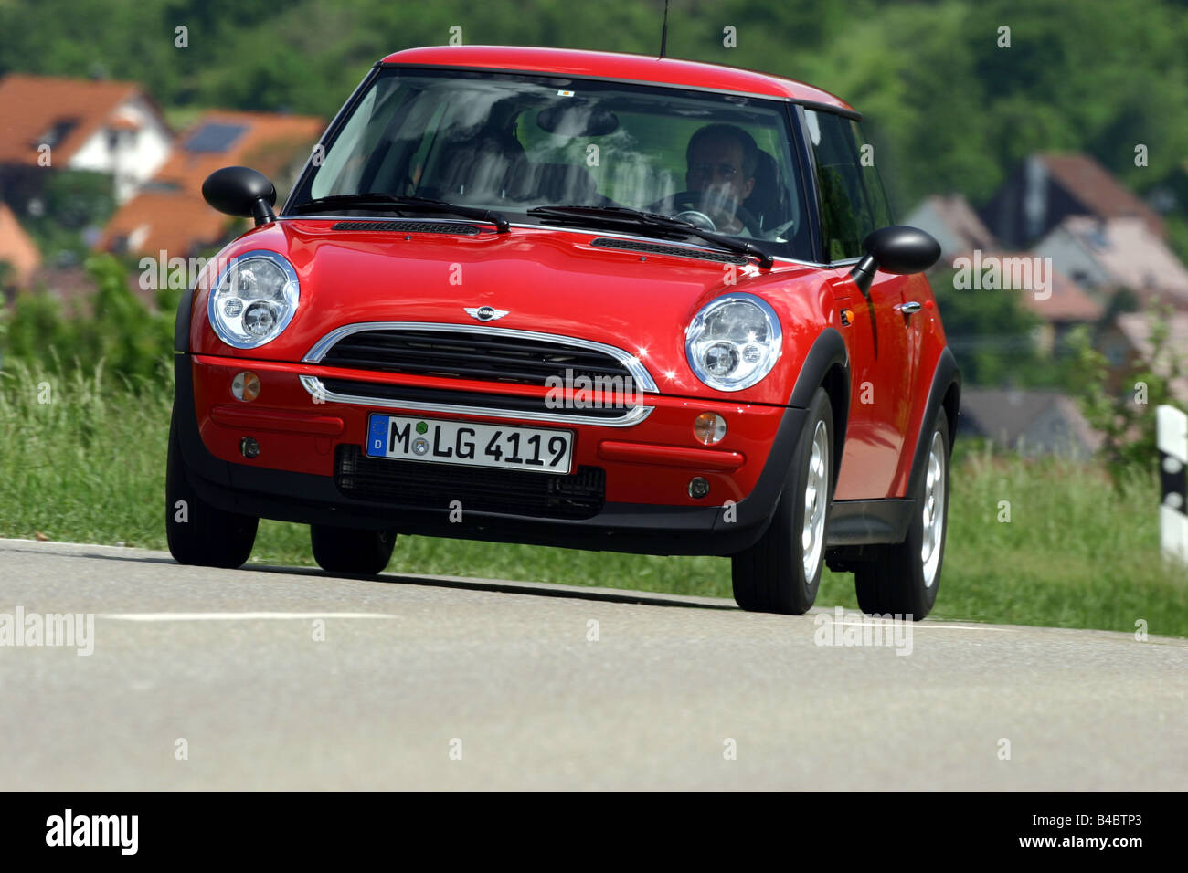 Car, Mini One D, Miniapprox.s, Limousine, model year 2001-, red, driving, diagonal from the front, frontal view, country road, p Stock Photo