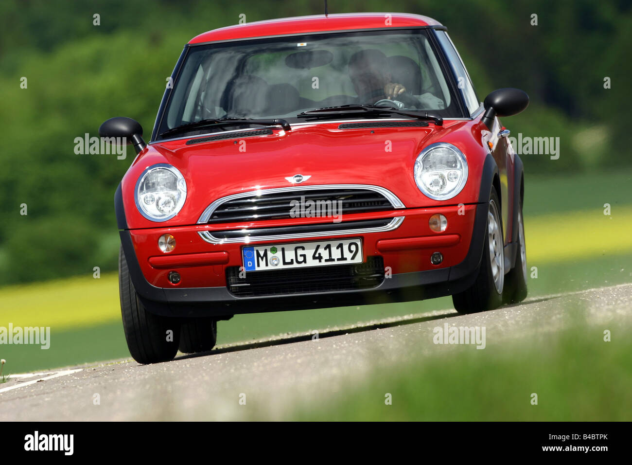 Car, Mini One D, Miniapprox.s, Limousine, model year 2001-, red, driving, diagonal from the front, frontal view, country road, p Stock Photo