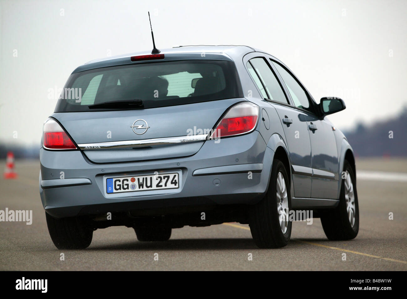 Car, Opel Astra, Limousine, Lower middle-sized class, model year 2003-,  silver/anthracite, driving, diagonal from the back, rear Stock Photo - Alamy