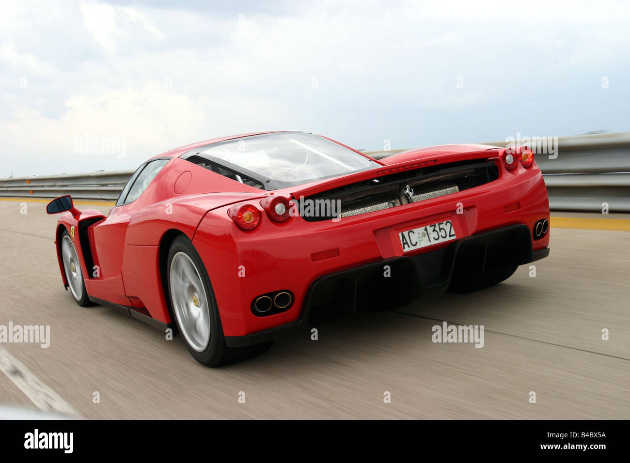 Car, Ferrari Enzo Ferrari, roadster, model year 2002-, Coupe/coupe, red, driving, diagonal from the back, rear view, test track, Stock Photo